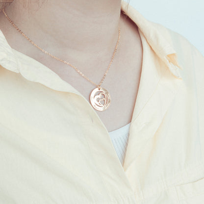 Two-Tone Circle & Heart Pendant Necklace (Sterling Silver & Copper): Macro shot highlighting the contrast between the silver circle and the copper heart. (Focuses on specific material combination and a unique visual element)