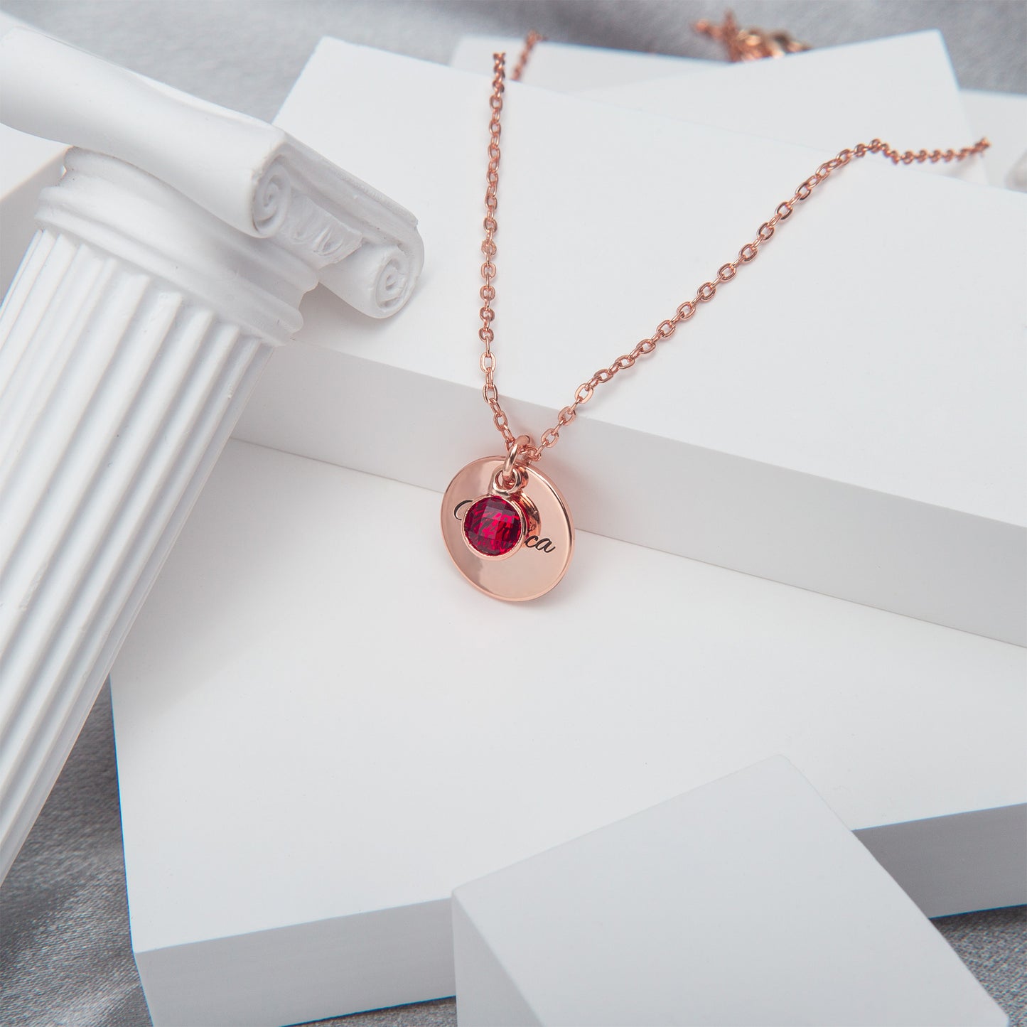 Close-up of a sterling silver circle pendant showcasing a vibrant [Birthstone Name/Color] gemstone, reflecting light beautifully. (Focuses on visual detail and material quality)