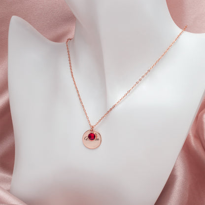 Model wearing a personalized copper circle birthstone necklace showcasing a deep red January Garnet, highlighting its elegant simplicity. (Emphasizes how it looks when worn and its style)