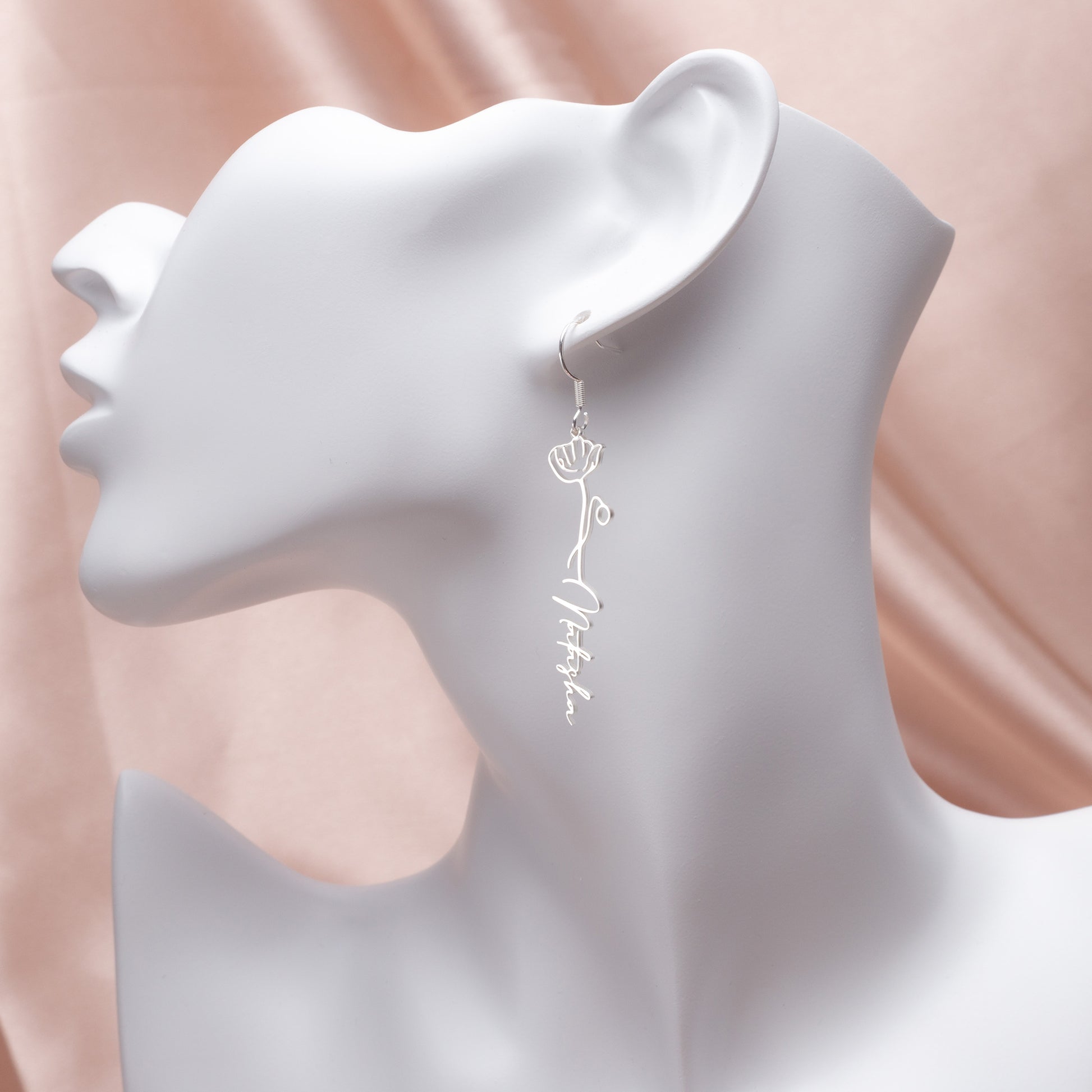 Side view of sterling silver floral hoop earrings emphasizing their lightweight design and secure clasp closure. (Highlights practical features and build quality)