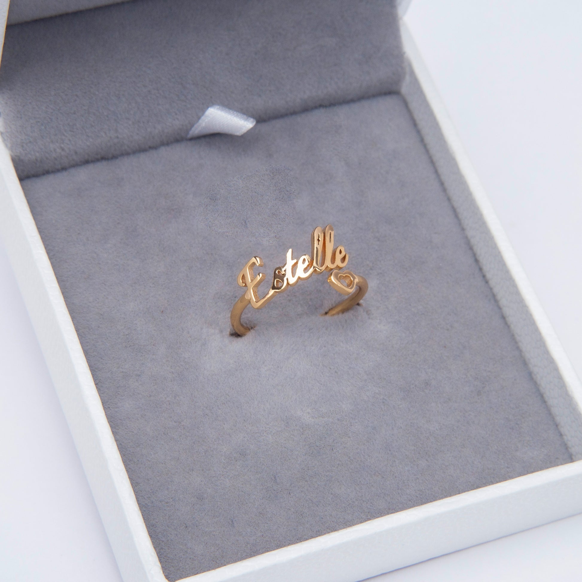 Detail shot of a Personalized Heart Name Ring in black stainless steel.Focus on the contrast between the dark metal and the engraved name "[Name Example - if applicable]".(Emphasizes a specific metal finish and the visual contrast)