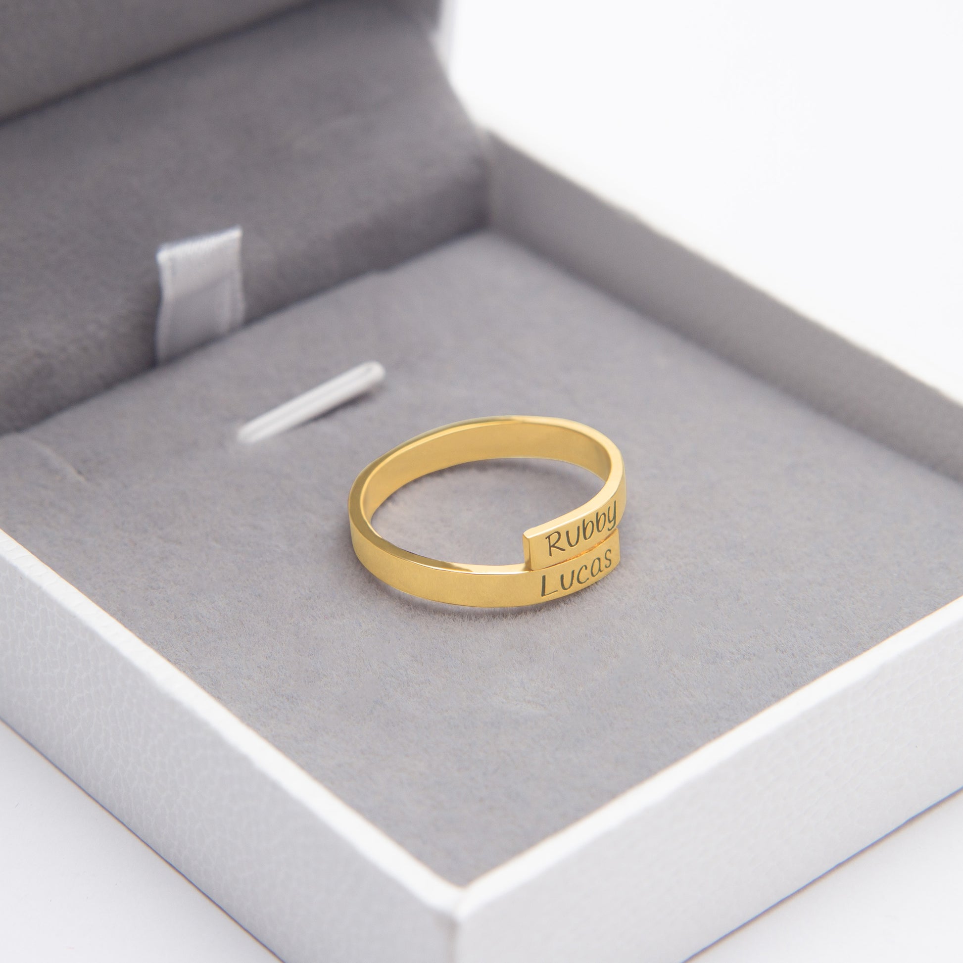 Engraved sterling silver couple's rings nestled in a velvet-lined gift box, showcasing "Forever Yours" inscription. (Focuses on a key feature: engraving and a specific example)