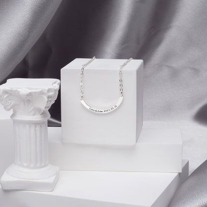 Gift box containing a Personalized Curved Bar Necklace in Sterling Silver, perfect for birthdays. (Emphasizes gifting and a specific occasion, ideal for a picture of the product in packaging)