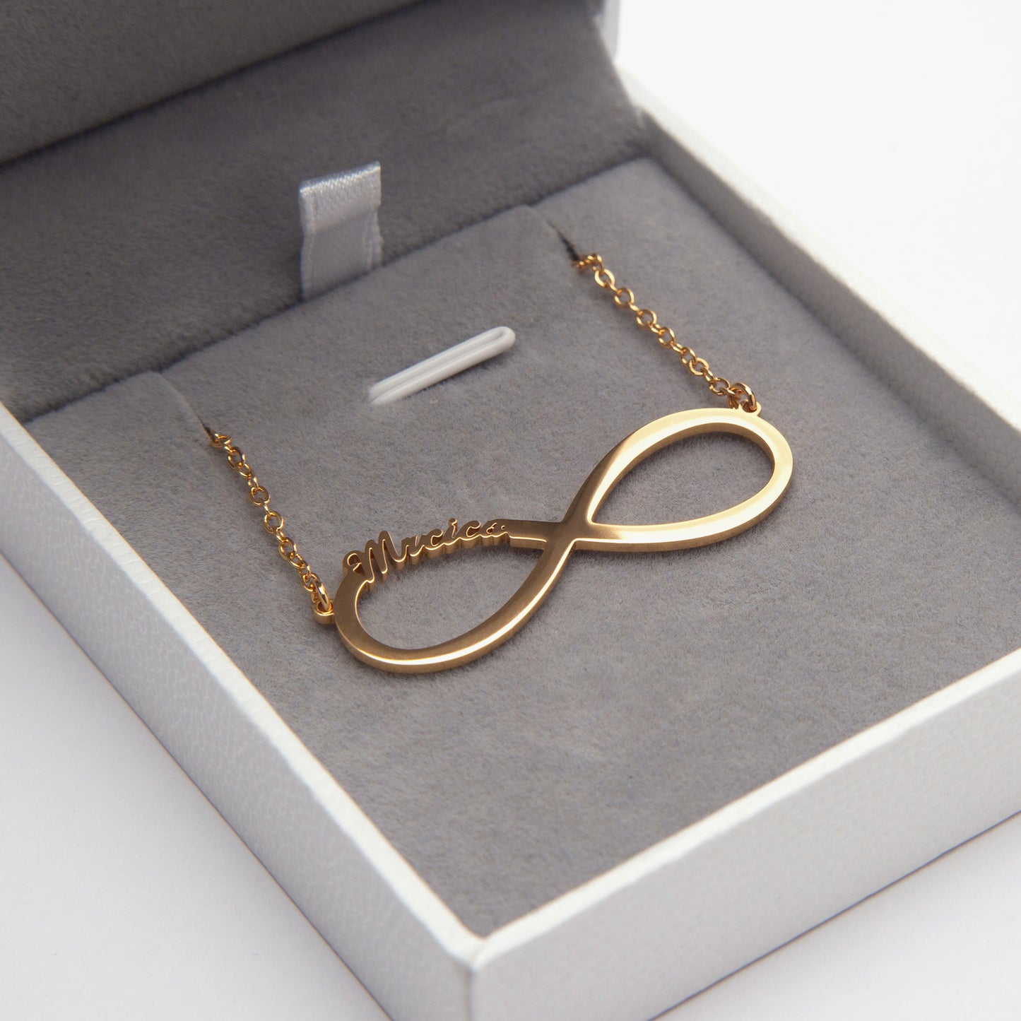 Close-up of a "Sarah" Personalized Infinity Name Necklace in Sterling Silver, nestled in its elegant gift box. (Focuses on a specific name example and highlights the material and packaging, good for a variant image showcasing the engraving detail)