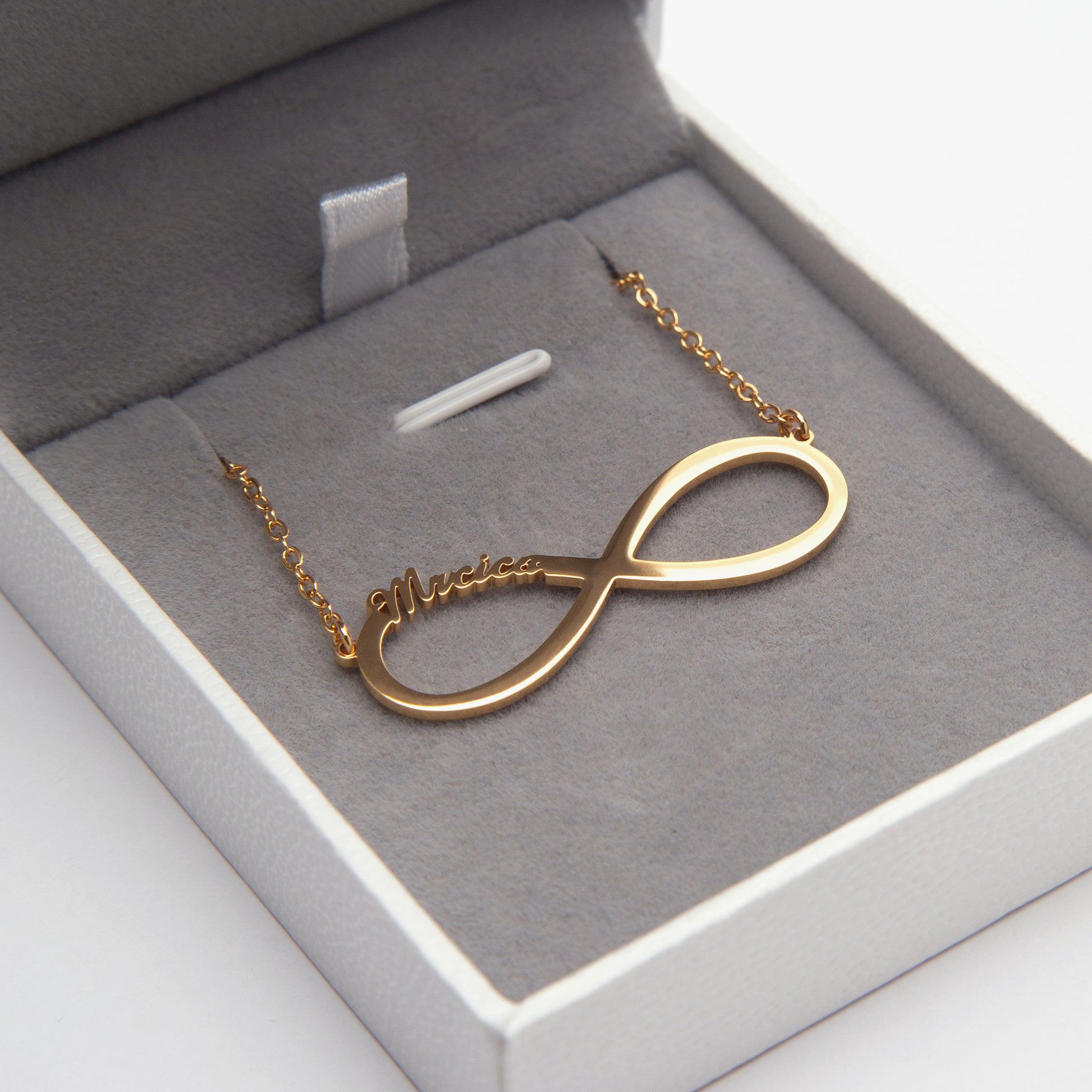 Close-up of a "Sarah" Personalized Infinity Name Necklace in Sterling Silver, nestled in its elegant gift box. (Focuses on a specific name example and highlights the material and packaging, good for a variant image showcasing the engraving detail)