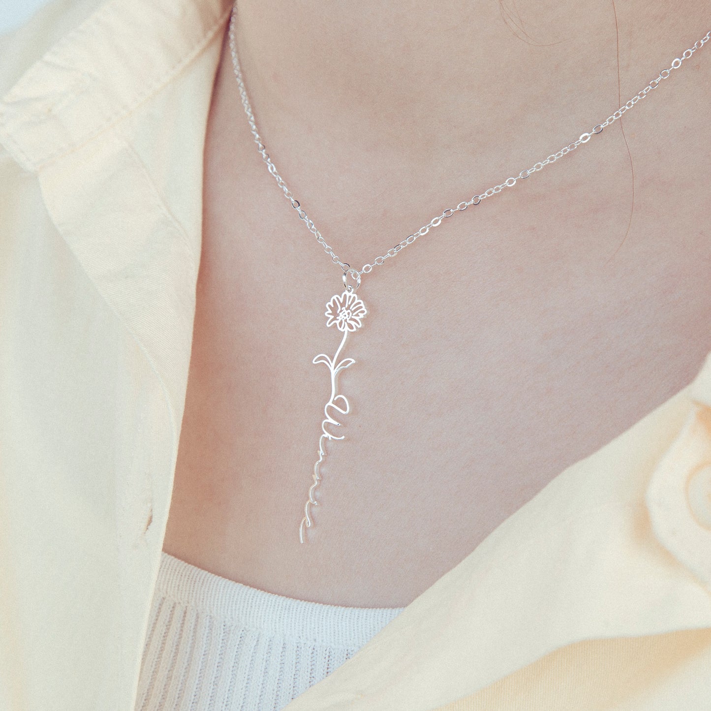 Delicate Rose and "Emily" engraved name necklace. This close-up showcases the craftsmanship of the stainless steel pendant and its personalized details, perfect for gifting a special keepsake. (Emphasizes craftsmanship and emotional value.)