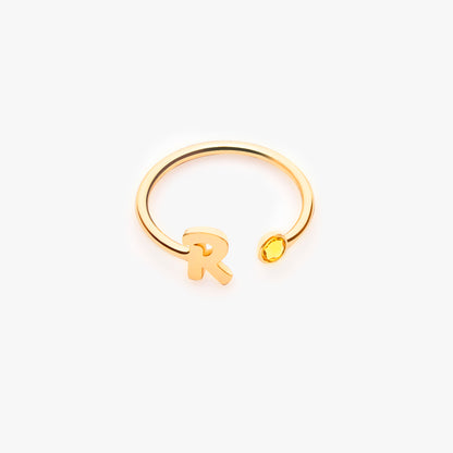 Rose gold personalized letter ring engraved with the initial 'B', displayed on a delicate finger. (Focuses on a different metal and letter, highlighting the personalization aspect and showcasing the ring on a model.)