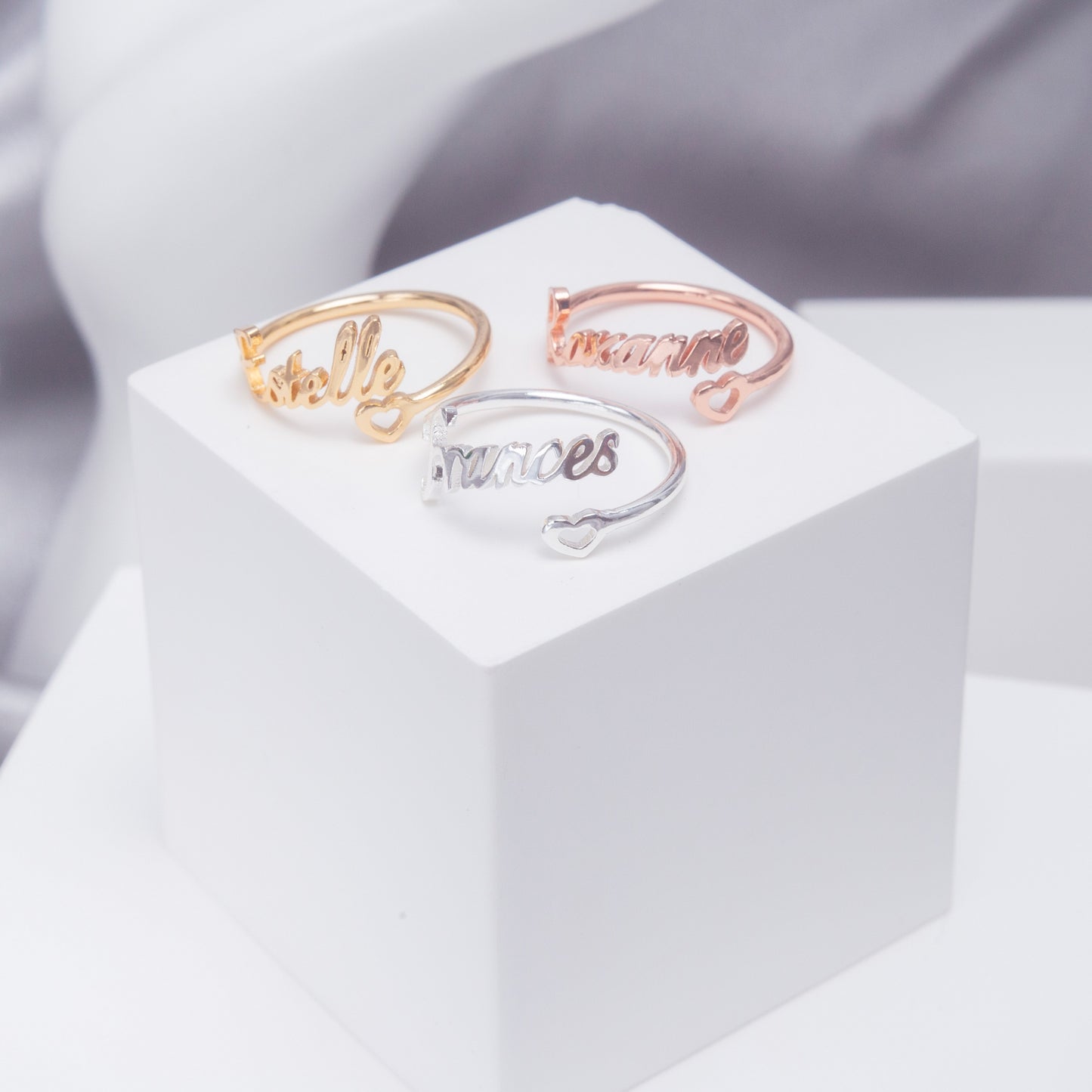 Rose gold Personalized Heart Name Ring nestled in a satin-lined gift box.Engraved with "[Name Example - if applicable]" on a delicate adjustable band. (Focuses on a specific metal variation & gift presentation)