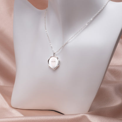 Side view: Irregular stainless steel pendant necklace, showcasing its varying thickness and how it hangs on the delicate chain against a white background. (Emphasizes dimensionality and how it sits when worn)