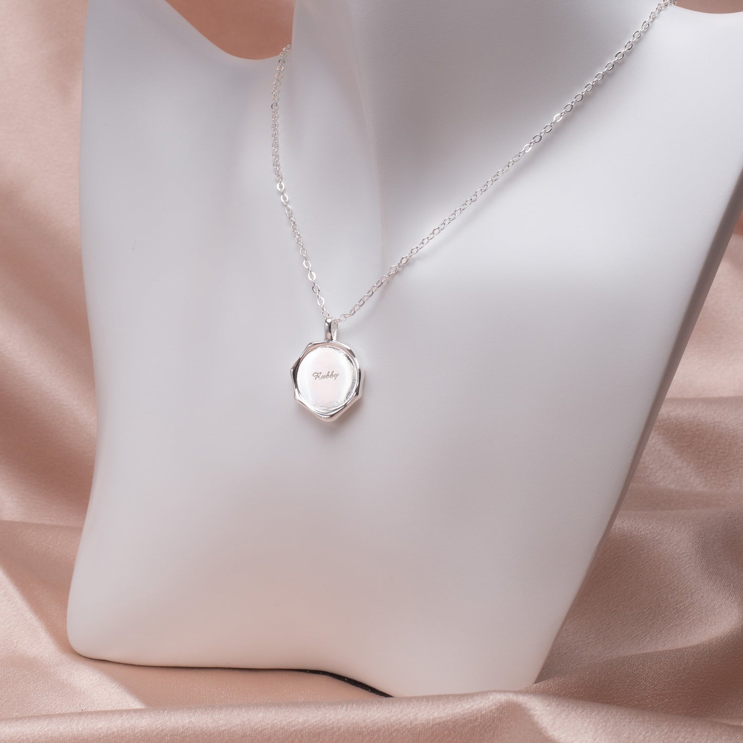 Close-up of Irregular Copper Pendant Necklace showcasing hammered texture on white background. (Focuses on texture and background)