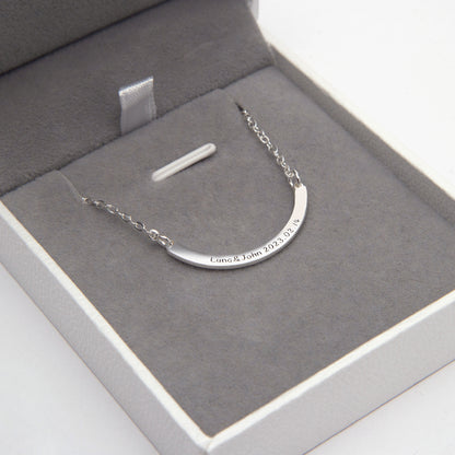 Close-up: Sterling Silver Personalized Curved Bar Necklace with "Emily" engraving. (Focuses on a specific engraving example and the close-up nature of the image)