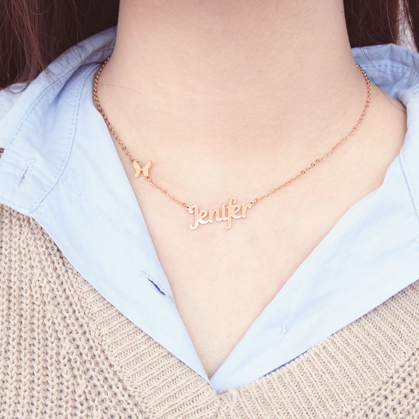 Model wearing a dainty butterfly necklace in sterling silver.Showcase how the pendant lays delicately against the skin. (Lifestyle image, emphasizes placement and feel)