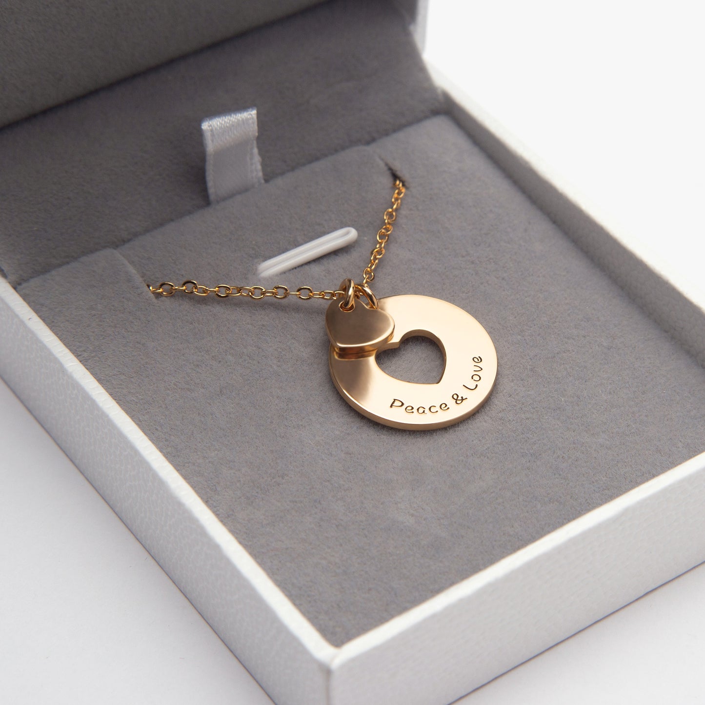 ALT Text: Two halves of a Love Heart Sharing Pendant, crafted from 925 Sterling Silver, Copper & Stainless Steel, nestled in a velvet-lined gift box.(Focuses on the "sharing" aspect and adds detail about the box)