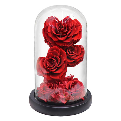 Top view of heart-shaped red rose in a clear glass dome.