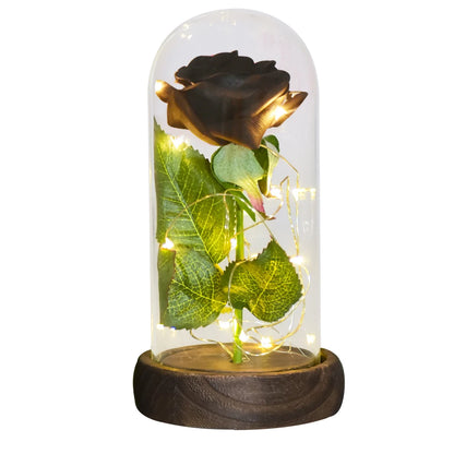 Preserved rose in glass dome, soft LED glow, romantic gift.