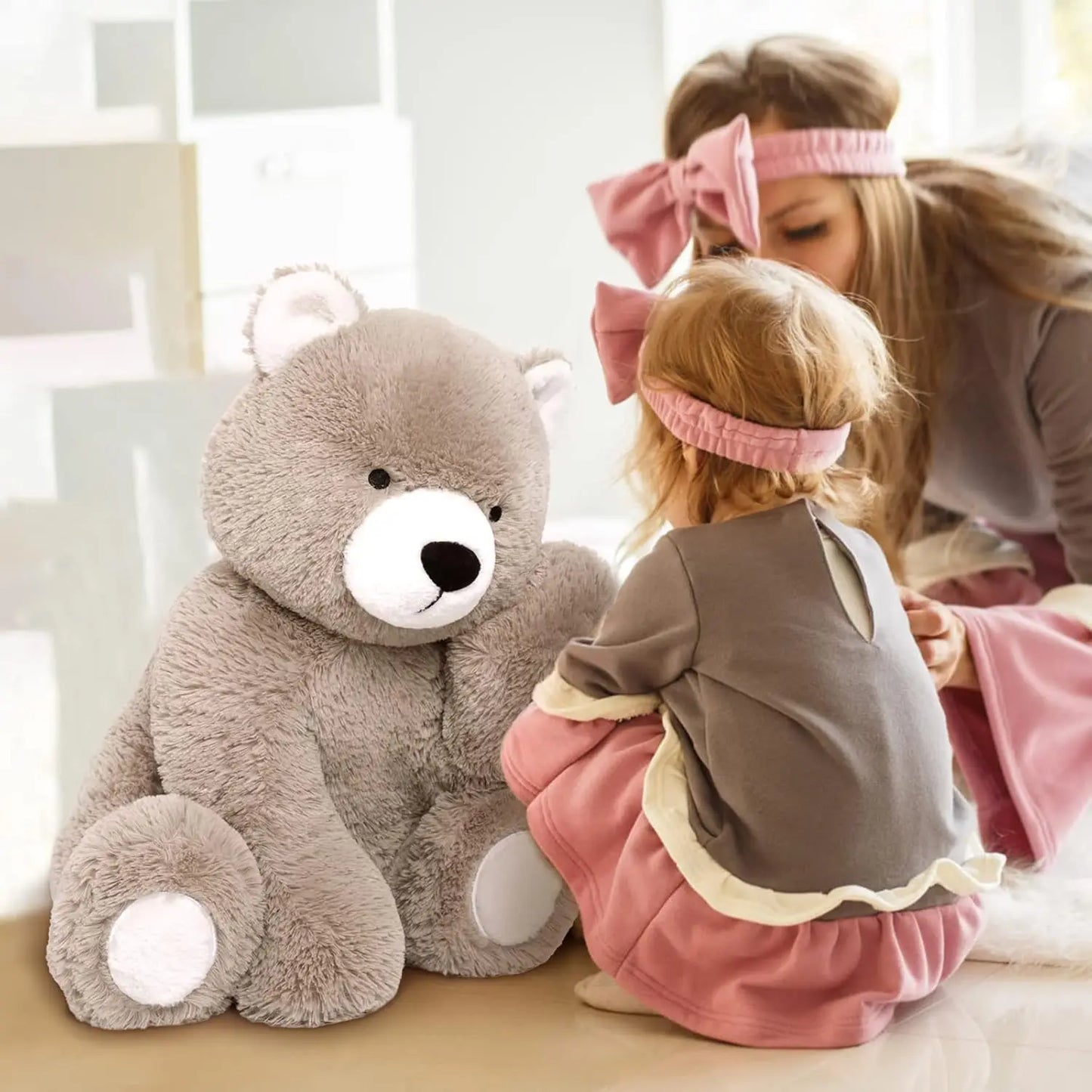 Brown teddy bear with pink ribbon, perfect for baby shower gift.