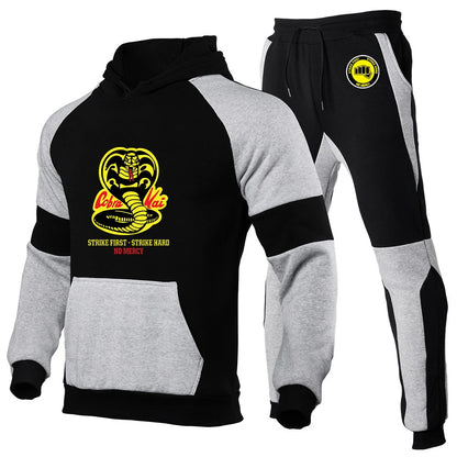 Cobra Kai tracksuit set, black joggers, elastic waistband, drawstring closure.