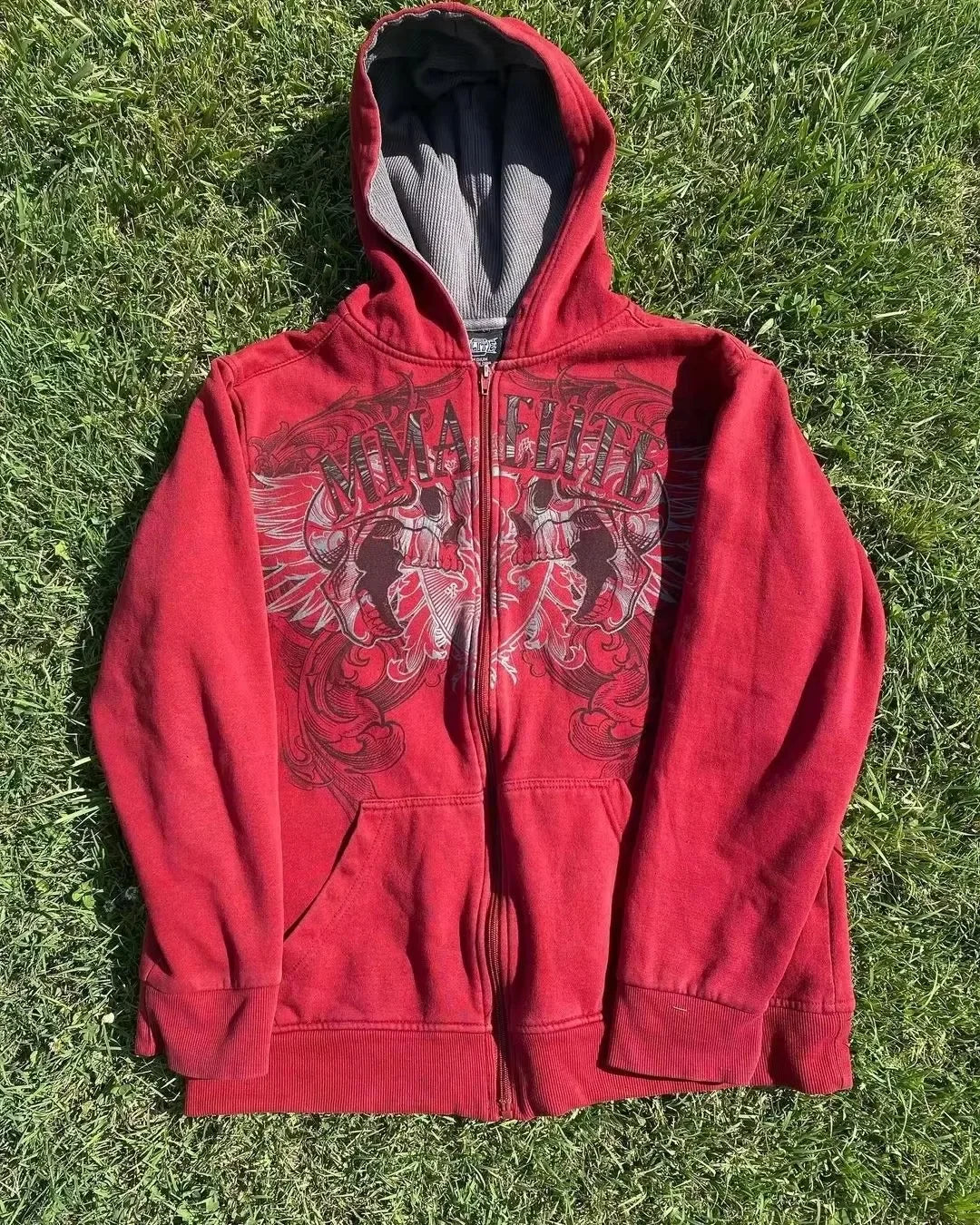 Close-up of skull and snake print on red Y2K couple hoodie.