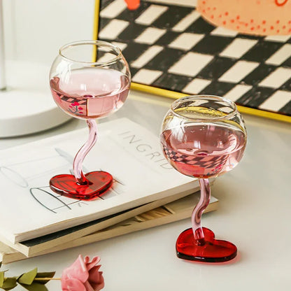 Pink heart-shaped champagne flute, side view.