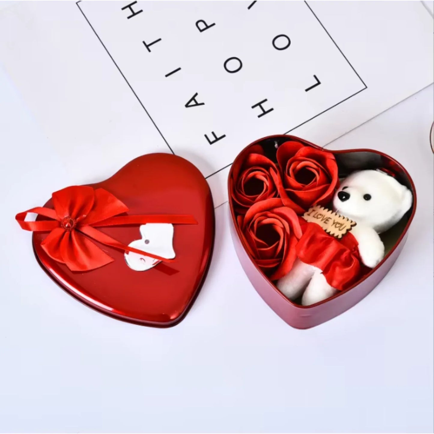 Top view of heart-shaped box with soap roses and teddy bear gift set.