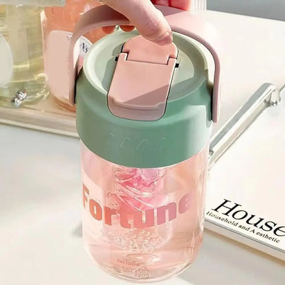 Pink 600ml reusable water bottle with straw, leak-proof design, made from eco-conscious materials.