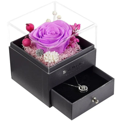 Preserved red rose in glass box, angled view, gift ribbon detail