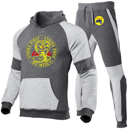 Cobra Kai tracksuit set, black joggers, elastic waistband, drawstring closure.