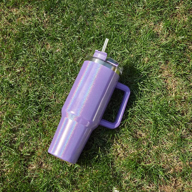 DUTRIEUX 40oz tumbler with straw, rainbow glitter, lifestyle shot with hand holding.