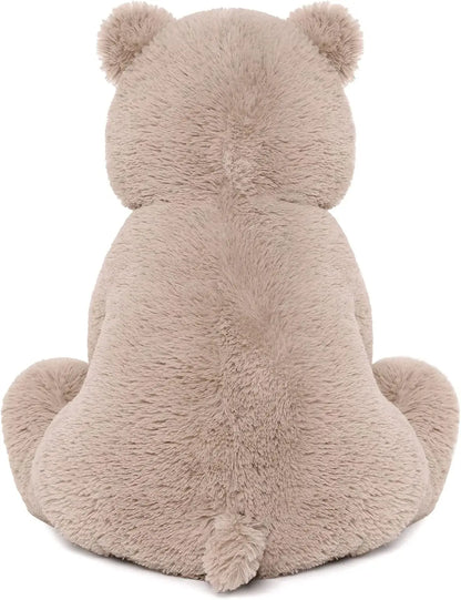 Teddy bear holding a small heart, ideal Valentine's Day gift.