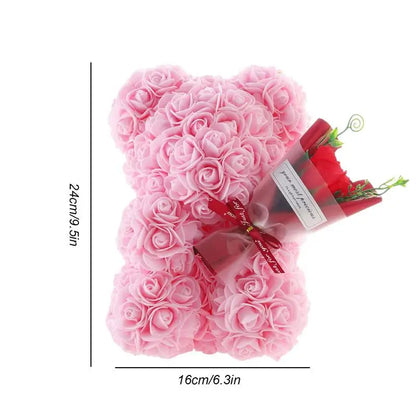 Top view of rose bear, delicate foam flowers, romantic Valentine's gift.