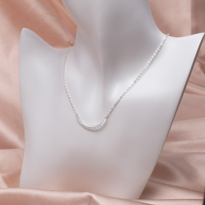 Model wearing a delicate Personalized Curved Bar Necklace in Sterling Silver, showcasing its adjustable length. (Highlights a key feature - adjustable length - and uses lifestyle imagery context)