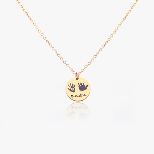 Personalized handprint necklace with the name [Example Name - e.g., Emily] in a script font, displayed on a [Chain Material - e.g., silver] chain. The necklace is shown in a gift box.