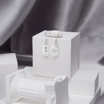 Stainless steel minimalist rose earrings personalized with "Mom," a thoughtful gift for Mother's Day, presented in a gift box. (Emphasizes stainless steel, targets a specific occasion/recipient, good for a lifestyle image)