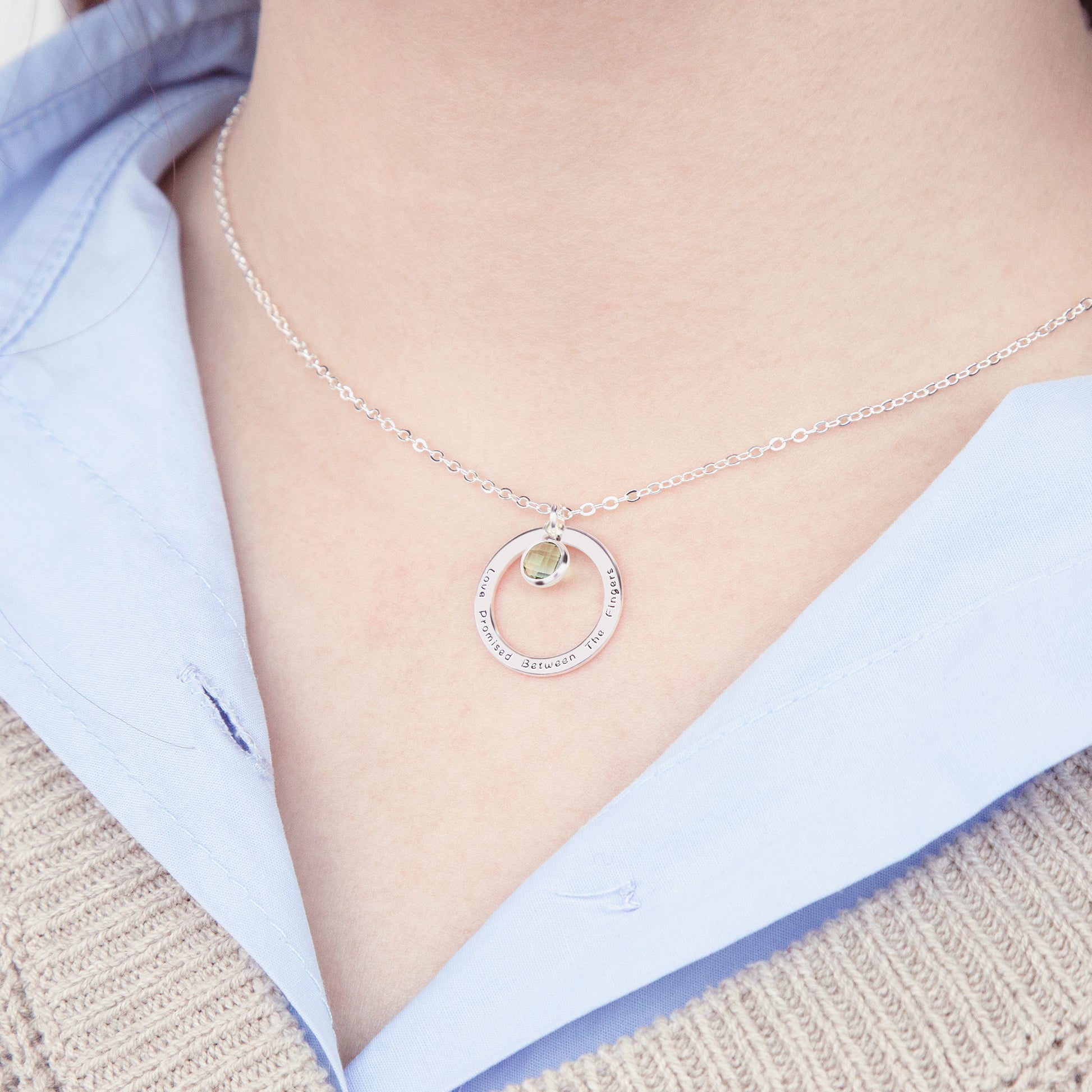 Person wearing a personalized [Birthstone Name/Color] birthstone necklace, demonstrating its subtle elegance and everyday wearability. (Illustrates the necklace in use and emphasizes its style.)